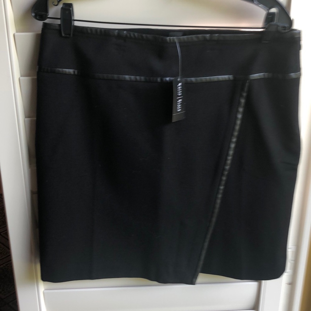 Washable black skirt, faux leather trim. Never worn.
